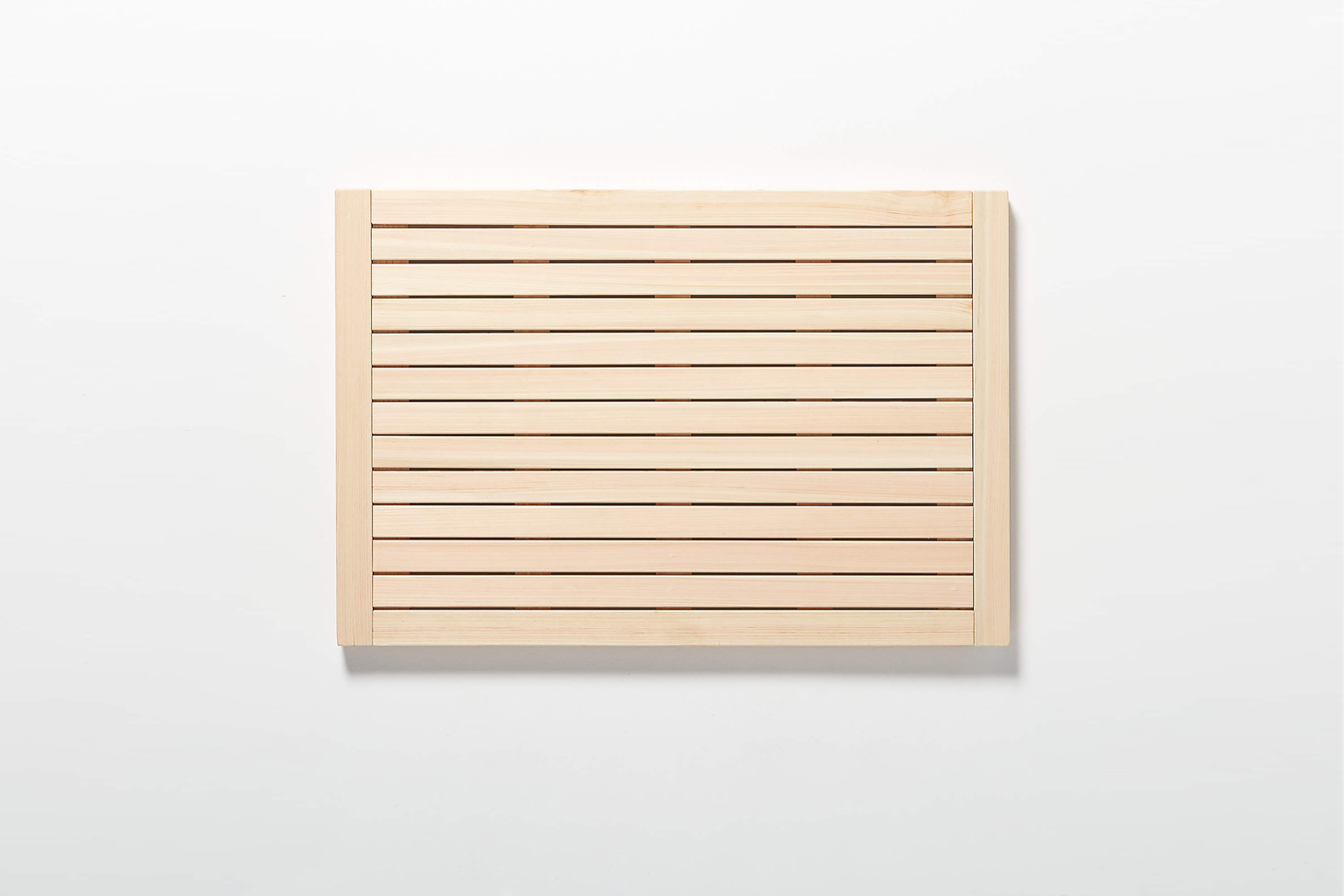 the lateral hinoki wood bath mat from cb\2 comes in two sizes: small for \$69.9 11