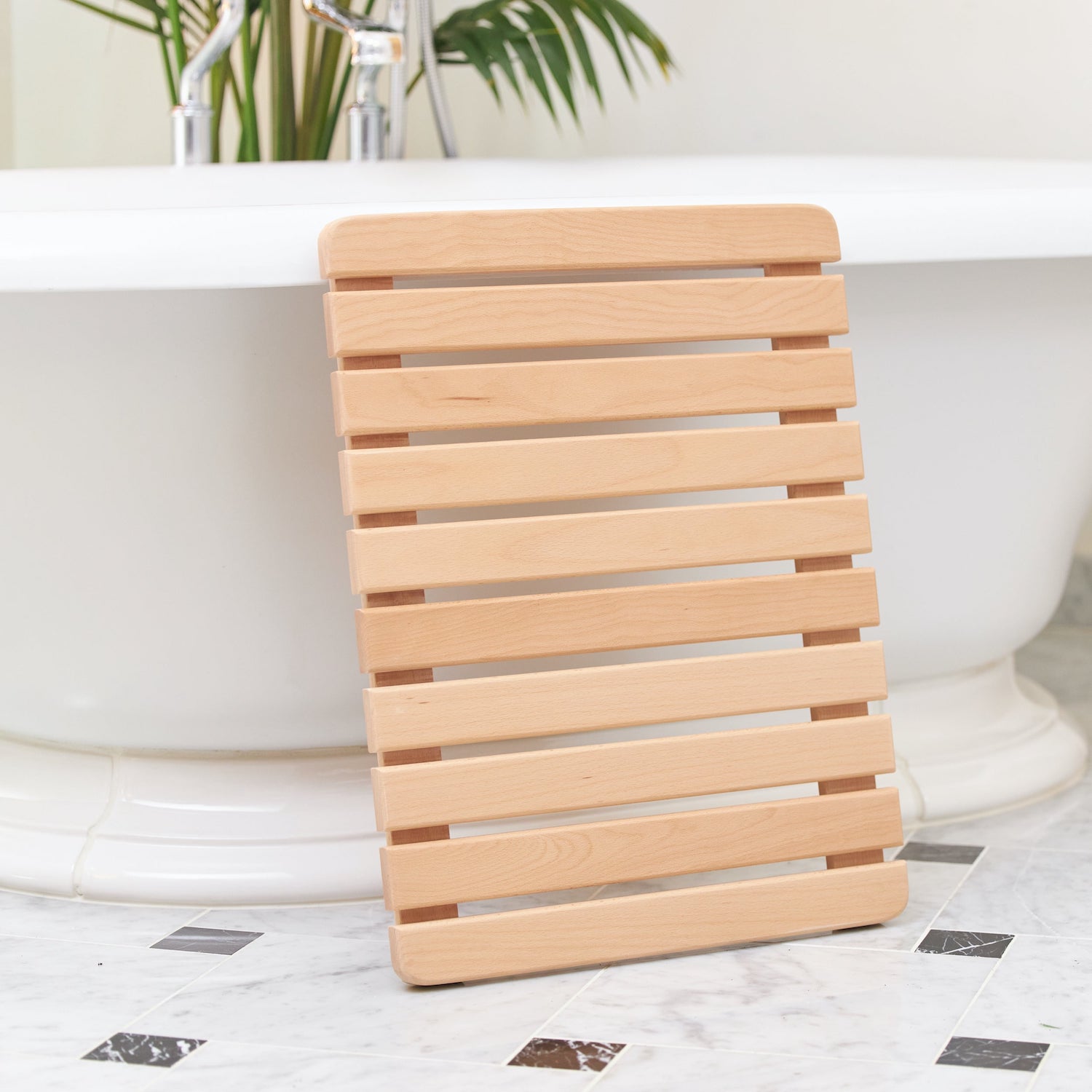 from avocado, the wooden bath mat has rounded corners and is made of beech; \$\ 14